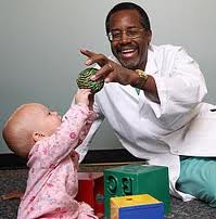 Dr. Carson playing with a child (John Hopkins Hospital  (Unknown))